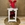 Candelabro blanco pequeño con flores en tonos rojos - Imagen 1